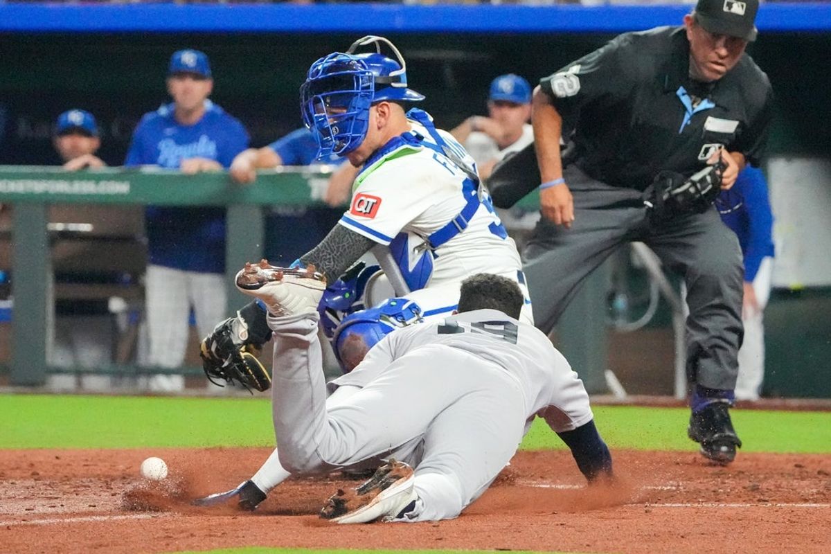 Jun 12, 2025; Kansas City, Missouri, USA; Kansas City Royals catcher Freddy Fermin (34) misses the tag as New York Yankees second baseman Pablo Reyes (19) scores in the eighth inning at Kauffman Stadium. Mandatory Credit: Denny Medley-Imagn Images