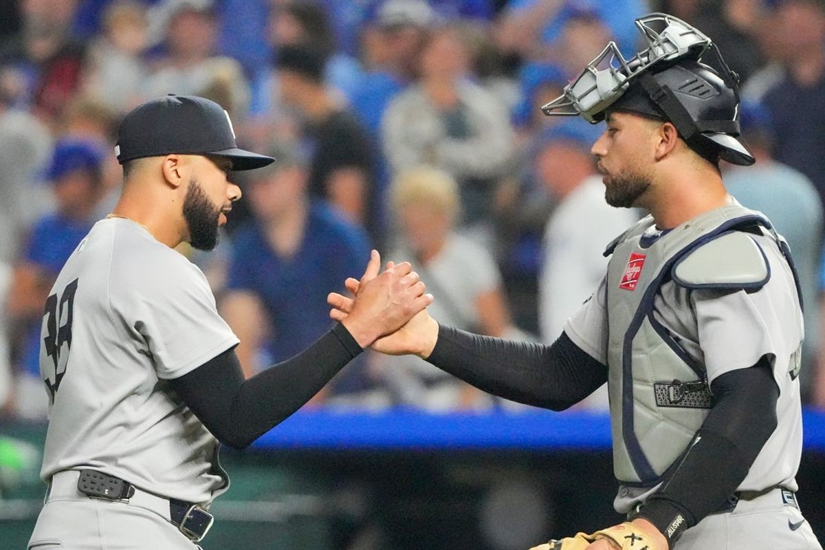 Jun 12, 2025; Kansas City, Missouri, USA; New York Yankees relief pitcher Devin Williams (38) celebrates with catcher J.C. Escarra (25) after the win over the Kansas City Royals at Kauffman Stadium. Mandatory Credit: Denny Medley-Imagn Images