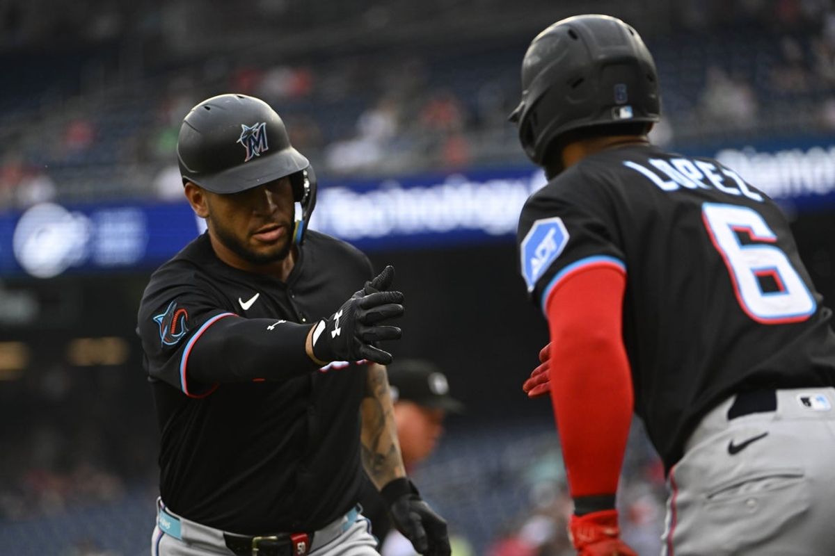 Jun 13, 2025; Washington, District of Columbia, USA; Miami Marlins designated hitter Agustin Ramirez (50) is congratulated by second baseman Otto Lopez (6) after hitting a solo home run against the Washington Nationals during the first inning at Nationals Park. Mandatory Credit: Brad Mills-Imagn Images