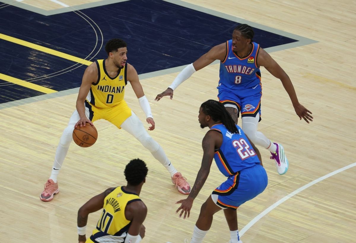 Jun 13, 2025; Indianapolis, Indiana, USA; Indiana Pacers guard Tyrese Haliburton (0) drives to the hoop past Oklahoma City Thunder guard Cason Wallace (22) and forward Jalen Williams (8) during the second quarter of game four of the 2025 NBA Finals at Gainbridge Fieldhouse. Mandatory Credit: Trevor Ruszkowski-Imagn Images