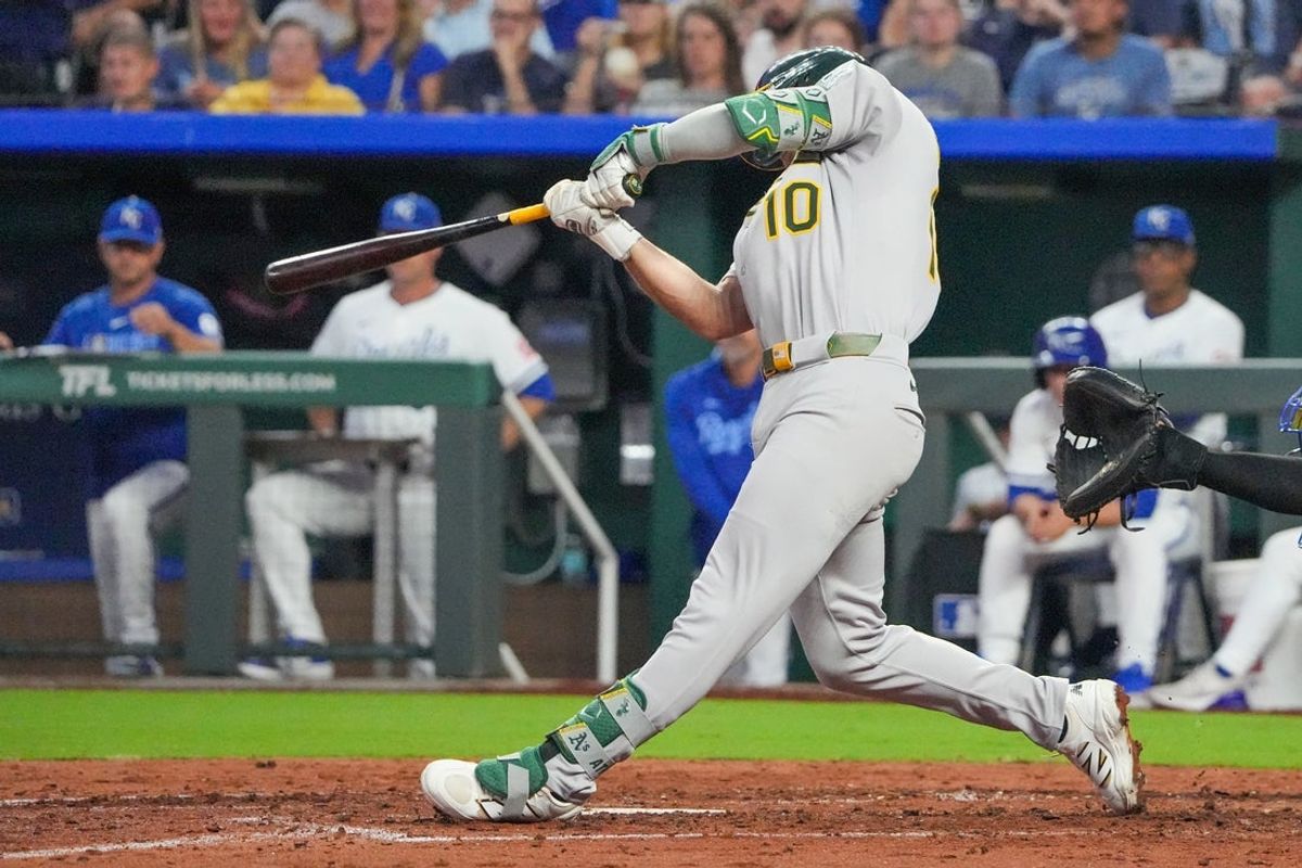 Jun 13, 2025; Kansas City, Missouri, USA; Athletics third baseman Max Muncy (10) hits a two run single against the Kansas City Royals in the sixth inning at Kauffman Stadium. Mandatory Credit: Denny Medley-Imagn Images