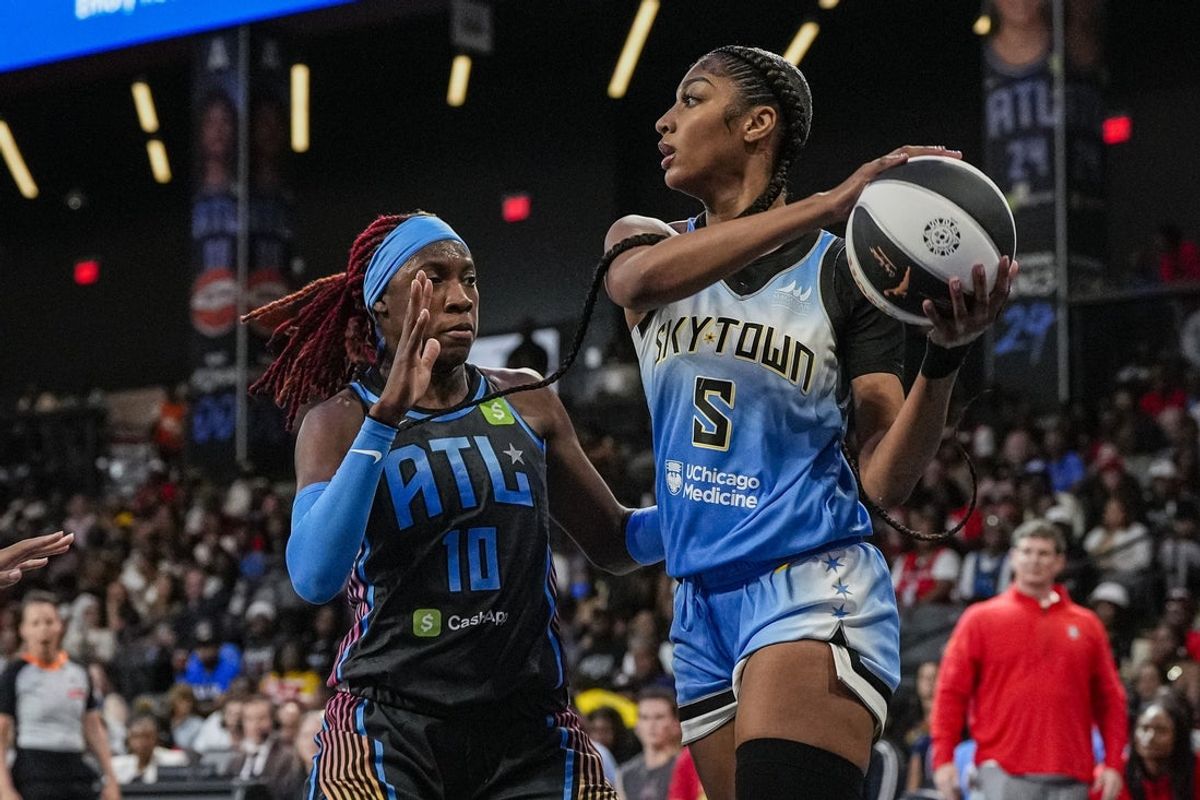 Jun 13, 2025; College Park, Georgia, USA; Chicago Sky forward Angel Reese (5) tries to pass defended by Atlanta Dream guard Rhyne Howard (10) during the first half at Gateway Center Arena at College Park. Mandatory Credit: Dale Zanine-Imagn Images