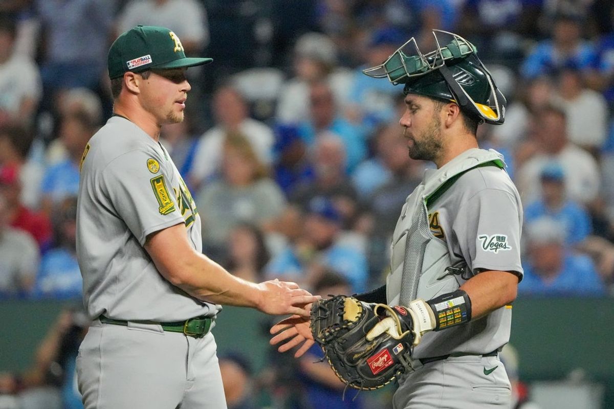 Jun 13, 2025; Kansas City, Missouri, USA; Athletics pitcher Mason Miller (19) celebrates with catcher Austin Wynns (29) after the win over the Kansas City Royals at Kauffman Stadium. Mandatory Credit: Denny Medley-Imagn Images
