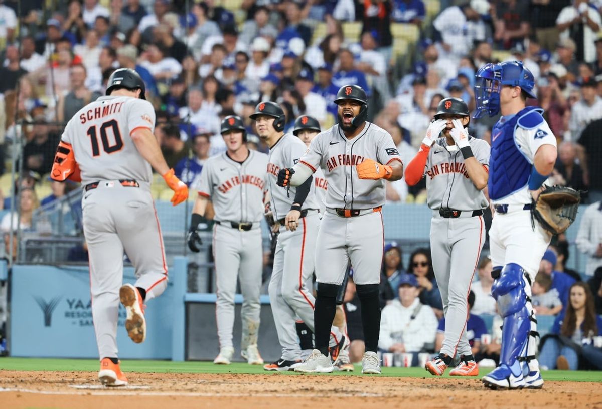 Jun 13, 2025; Los Angeles, California, USA; San Francisco Giants players celebrate at home plate after San Francisco Giants first baseman Casey Schmitt (10) hits a grand slam home run during the third inning against the Los Angeles Dodgers at Dodger Stadium. Mandatory Credit: William Navarro-Imagn Images