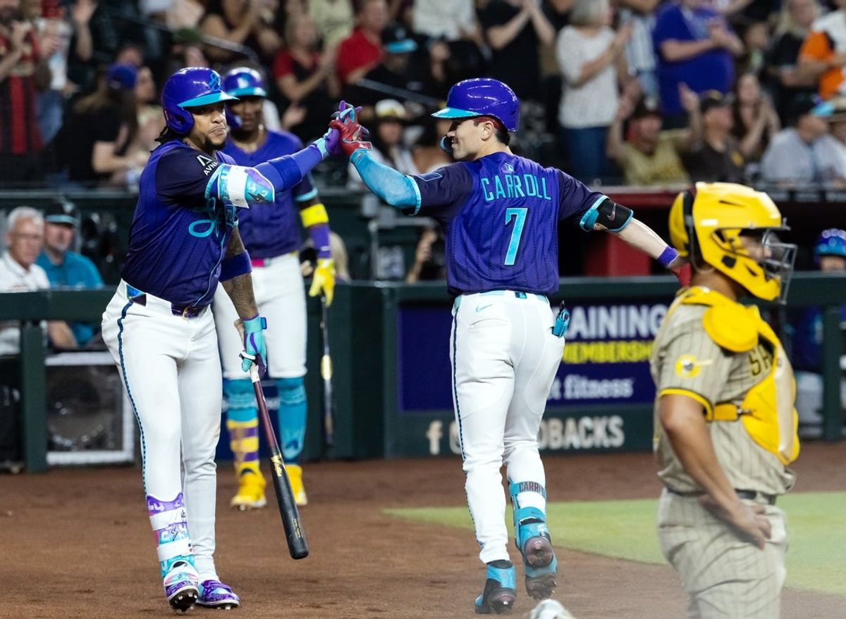 Jun 13, 2025; Phoenix, Arizona, USA; Arizona Diamondbacks outfielder Corbin Carroll (7) celebrates with Ketel Marte after hitting a solo home run in the fifth inning against the San Diego Padres at Chase Field. Mandatory Credit: Mark J. Rebilas-Imagn Images