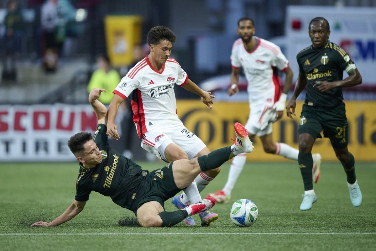 Jun 13, 2025; Portland, Oregon, USA; Portland Timbers midfielder David Ayala (24) slide tackles San Jose Earthquakes midfielder Beau Leroux (34) during the first half at Providence Park. Mandatory Credit: Troy Wayrynen-Imagn Images