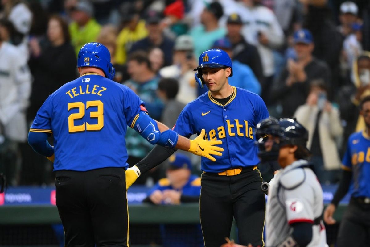 Jun 13, 2025; Seattle, Washington, USA; Seattle Mariners first baseman Rowdy Tellez (23) and right fielder Dominic Canzone (8) celebrate after Tellez hit a home run against the Cleveland Guardians during the fourth inning at T-Mobile Park. Mandatory Credit: Steven Bisig-Imagn Images