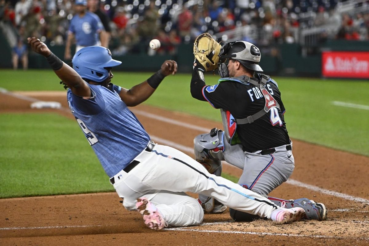 Jun 13, 2025; Washington, District of Columbia, USA; Washington Nationals designated hitter Josh Bell (19) scores past Miami Marlins catcher Nick Fortes (4) during the seventh inning at Nationals Park. Mandatory Credit: Brad Mills-Imagn Images