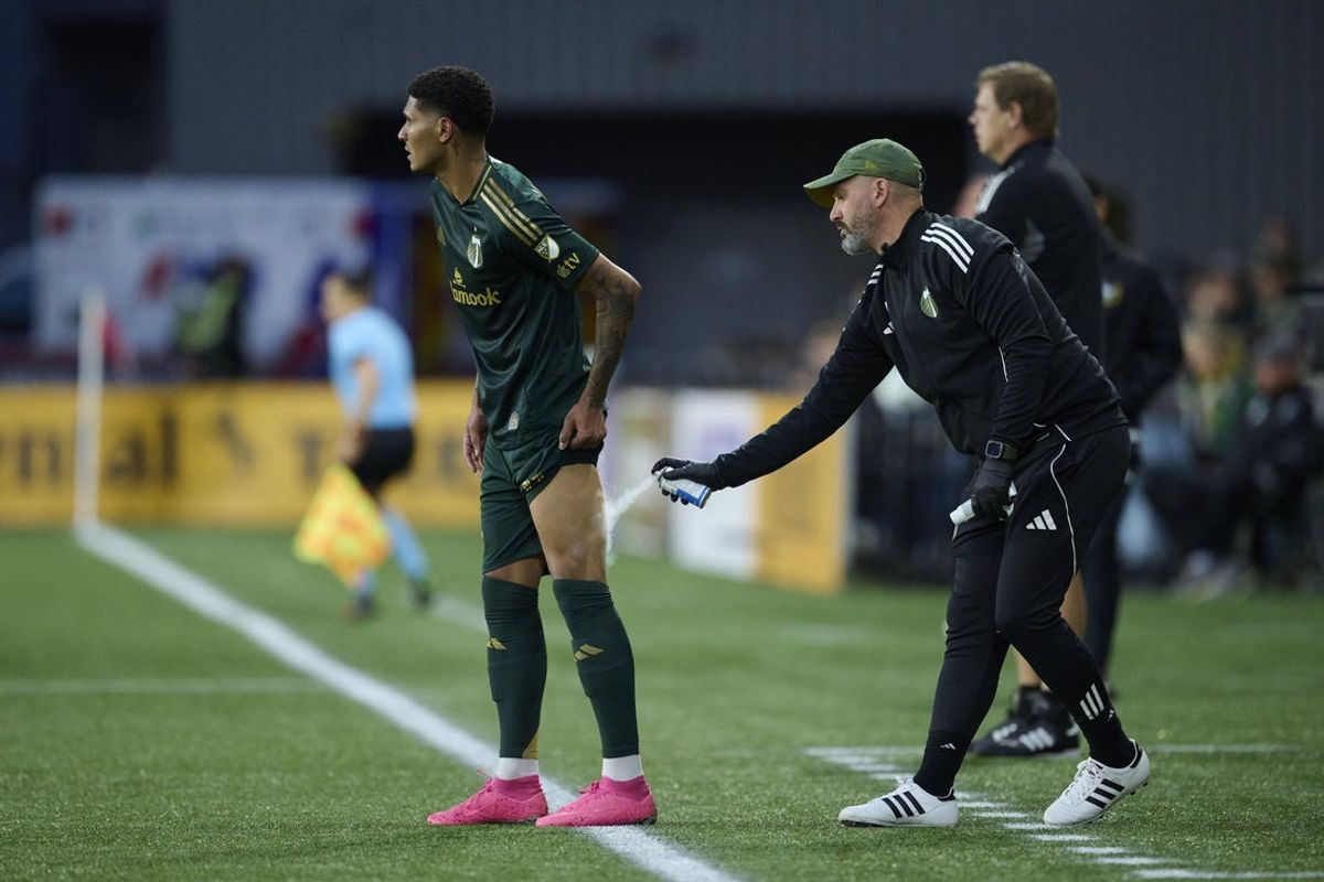 Jun 13, 2025; Portland, Oregon, USA; A trainer sprays the leg of Portland Timbers forward Antony (11) during the second half against the San Jose Earthquakes at Providence Park. Mandatory Credit: Troy Wayrynen-Imagn Images
