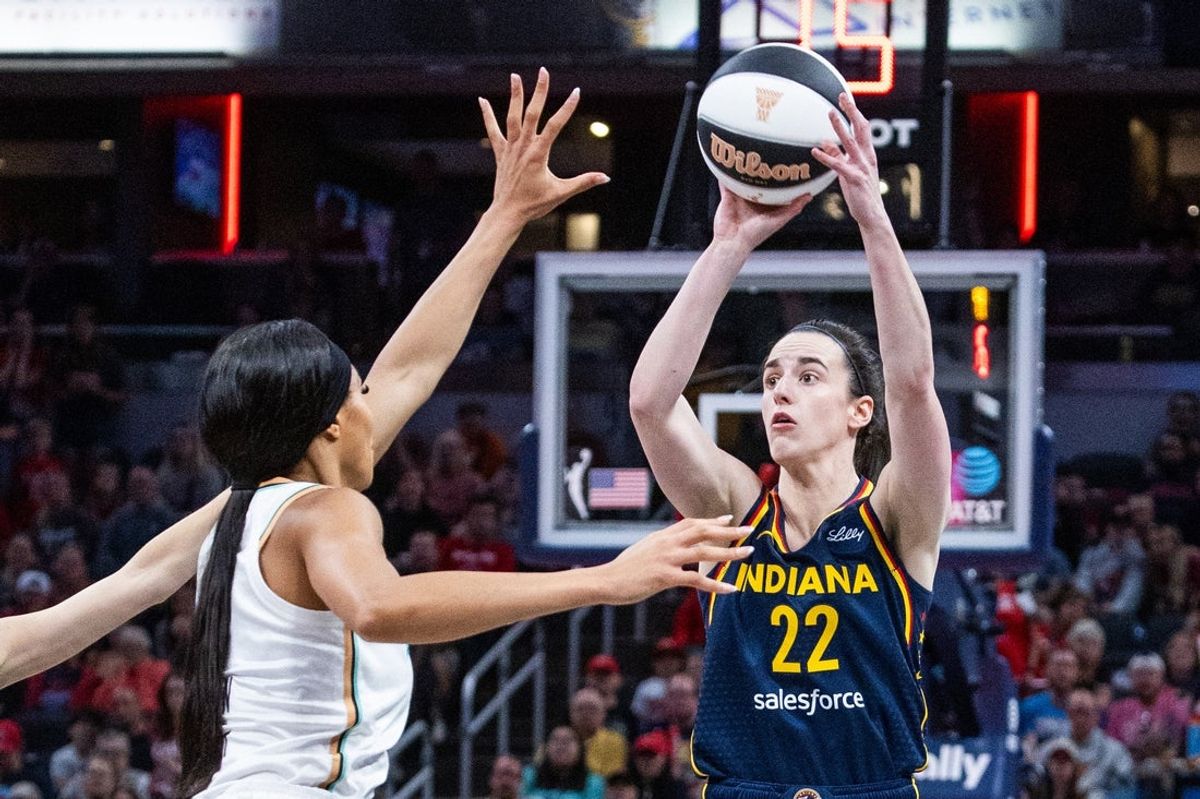 Jun 14, 2025; Indianapolis, Indiana, USA; Indiana Fever guard Caitlin Clark (22) shoots the ball while New York Liberty forward Kennedy Burke (22) defends in the first half at Gainbridge Fieldhouse. Mandatory Credit: Trevor Ruszkowski-Imagn Images