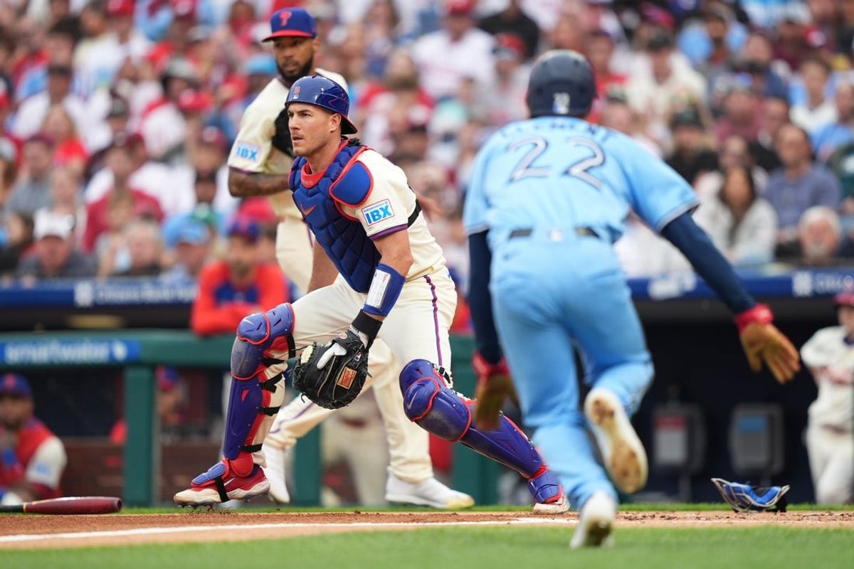 Jun 14, 2025; Philadelphia, Pennsylvania, USA; Philadelphia Phillies catcher J.T. Realmuto (10) defends the plate as Toronto Blue Jays infielder Ernie Clement (22) advances home to score in the second inning at Citizens Bank Park. Mandatory Credit: Kyle Ross-Imagn Images