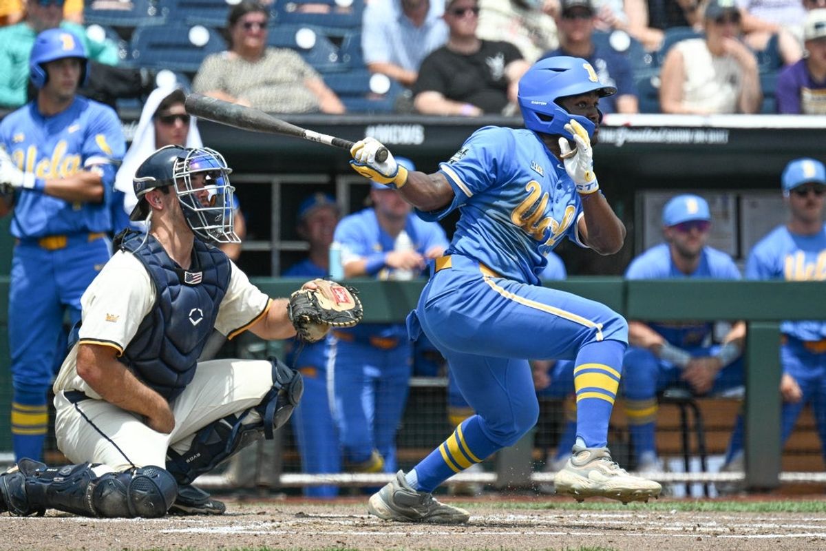 Jun 14, 2025; Omaha, Neb, USA;  UCLA Bruins left fielder Dean West (36) hit a RBI single against the Murray State Racers during the second inning at Charles Schwab Field. Mandatory Credit: Steven Branscombe-Imagn Images