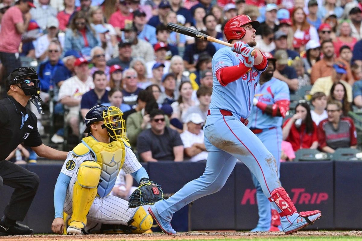Jun 14, 2025; Milwaukee, Wisconsin, USA;  St. Louis Cardinals second baseman Nolan Gorman (16) hits a 3-run home run as Milwaukee Brewers catcher William Contreras (24) looks on in the fifth inning at American Family Field. Mandatory Credit: Benny Sieu-Imagn Images