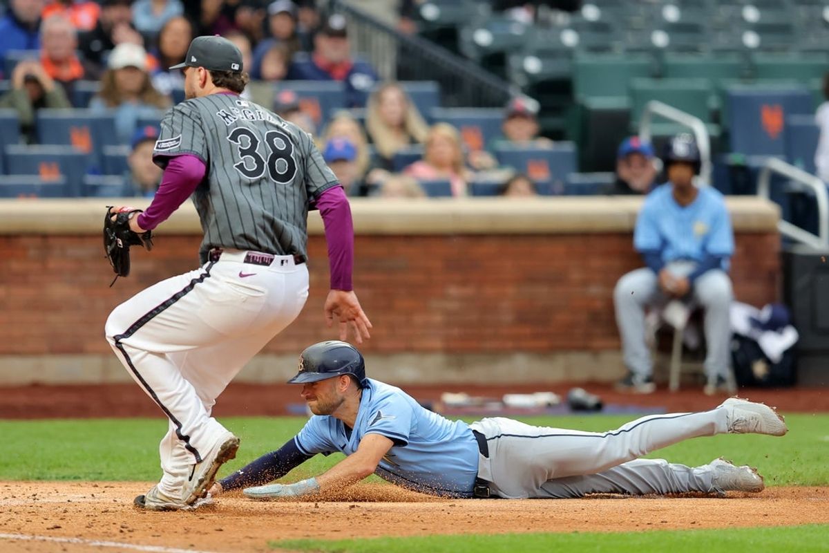 Jun 14, 2025; New York City, New York, USA; Tampa Bay Rays second baseman Brandon Lowe (8) scores from third base on a wild pitch by New York Mets starting pitcher Tylor Megill (38) during the fourth inning at Citi Field. Mandatory Credit: Brad Penner-Imagn Images