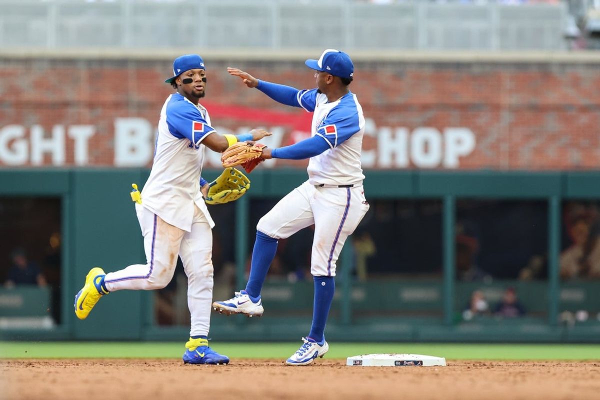 Jun 14, 2025; Cumberland, Georgia, USA; Atlanta Braves outfielder Ronald Acuna Jr. (13) and Atlanta Braves second base Ozzie Albies (1) shake hands after a victory against the Colorado Rockies at Truist Park. Mandatory Credit: Jordan Godfree-Imagn Images