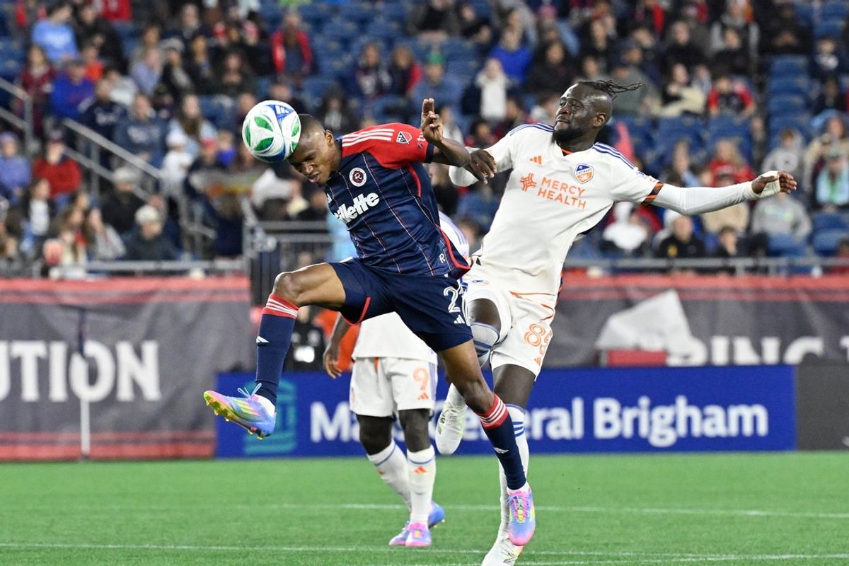 Jun 14, 2025; Foxborough, Massachusetts, USA; New England Revolution defender Mamadou Fofana (2) head the ball while defended by FC Cincinnati forward Kei Kamara (85) during the first half at Gillette Stadium. Mandatory Credit: Eric Canha-Imagn Images