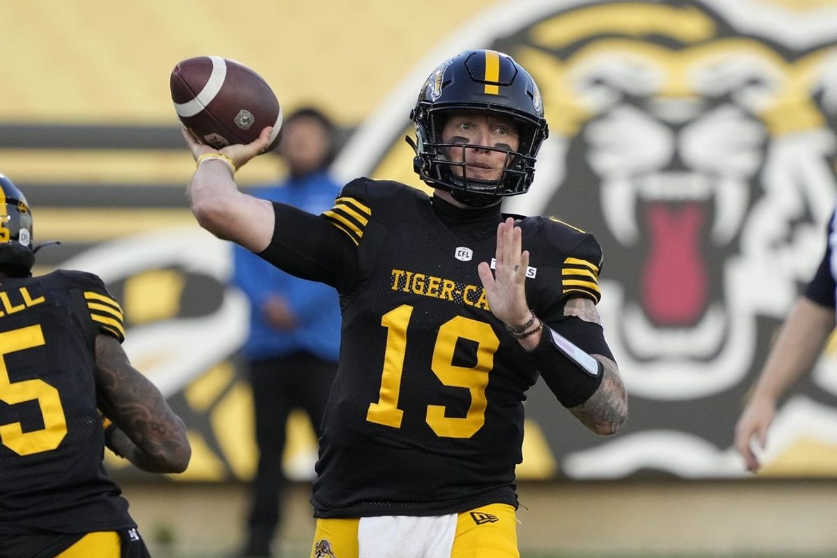 Jun 14, 2025; Hamilton, Ontario, Canada; Hamilton Tiger-Cats quarterback Bo Levi Mitchell (19) throws a pass against the Saskatchewan Roughriders during the first half at Hamilton Stadium. Mandatory Credit: John E. Sokolowski-Imagn Images