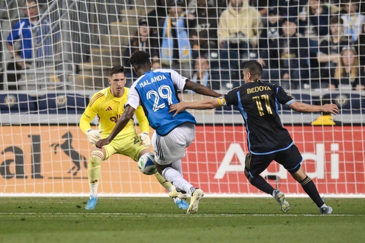Jun 14, 2025; Chester, Pennsylvania, USA; Charlotte FC defender Adilson Malanda (29) clears the ball away from Philadelphia Union midfielder Alejandro Bedoya (11) as goalkeeper David Bingham (22) defends the goal during the first half at Subaru Park. Mandatory Credit: John Jones-Imagn Images