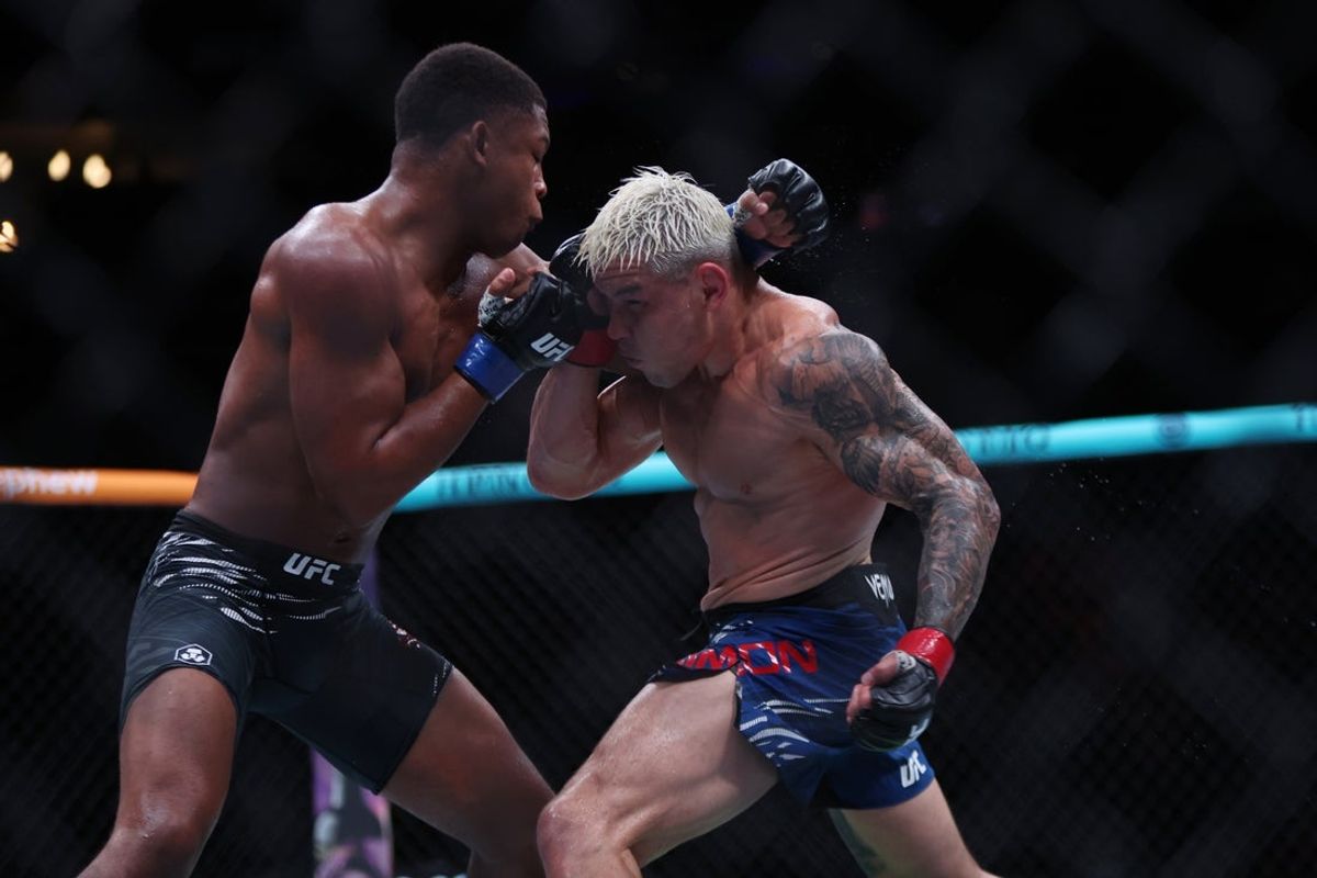 Jun 14, 2025; Atlanta, Georgia, UNITED STATES; Ricky Simon (red gloves) fights Cameron Smotherman (blue gloves) during UFC Fight Night at State Farm Arena. Mandatory Credit: Brett Davis-Imagn Images