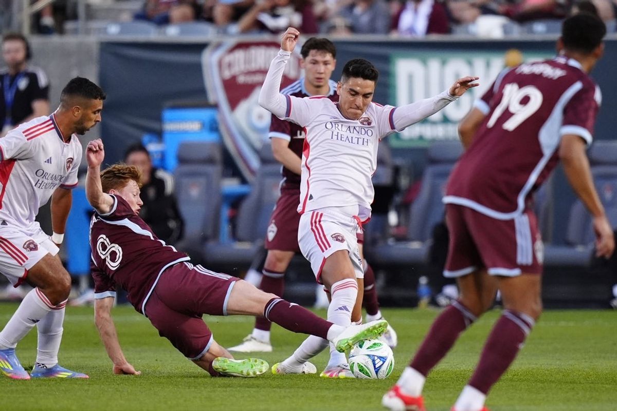Jun 14, 2025; Commerce City, Colorado, USA; Colorado Rapids midfielder Oliver Larraz (8) defends on Orlando City midfielder Eduard Atuesta (20) in the first half at Dick's Sporting Goods Park. Mandatory Credit: Ron Chenoy-Imagn Images