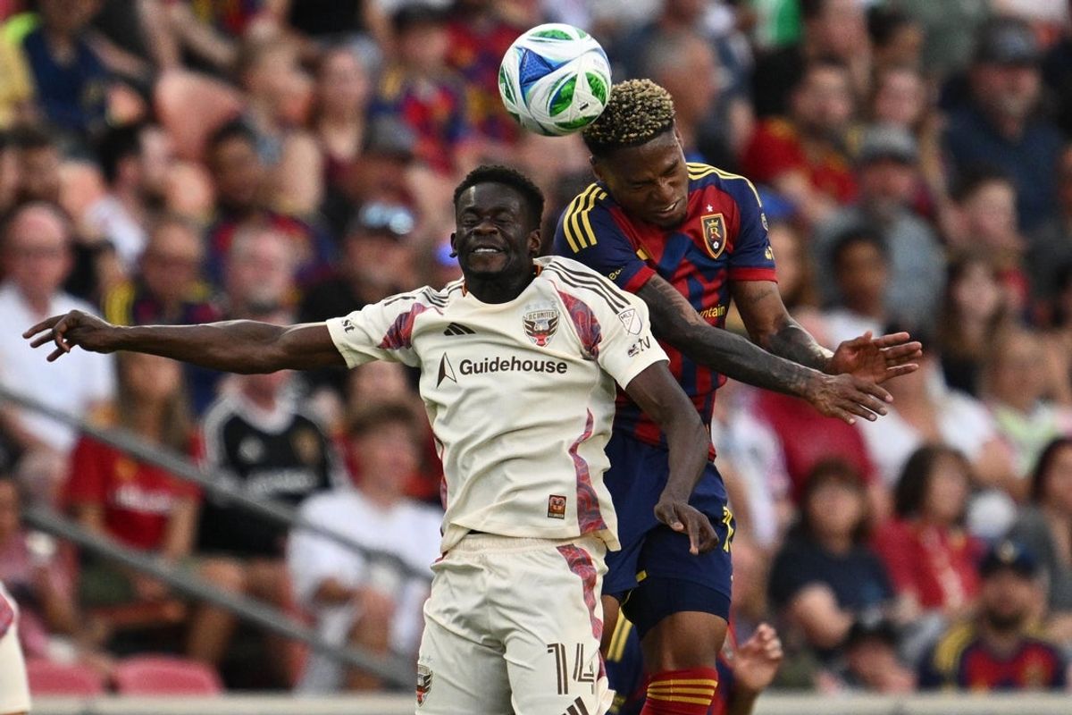 Jun 14, 2025; Sandy, Utah, USA;  DC United forward Dominique Badji (14) and Real Salt Lake midfielder Nelson Palacio (13) battle for control of the ball in the first half at America First Field. Mandatory Credit: Jamie Sabau-Imagn Images
