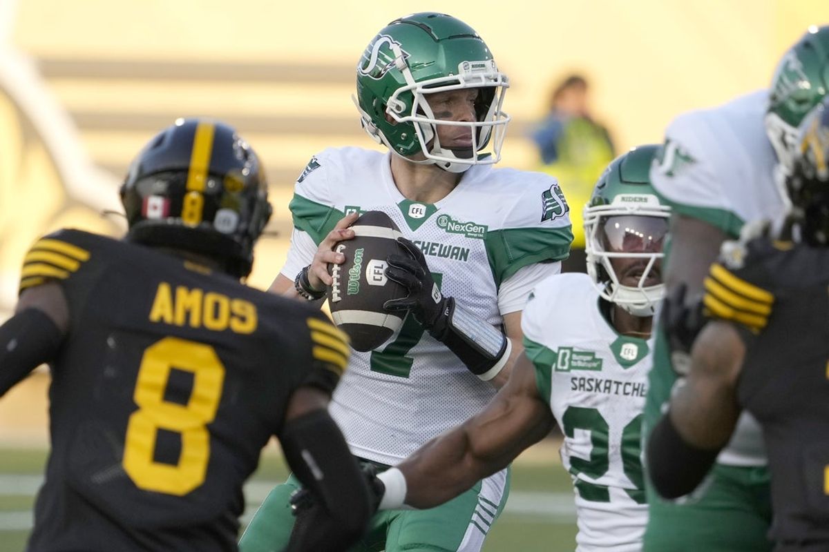 Jun 14, 2025; Hamilton, Ontario, Canada; Saskatchewan Roughriders quarterback Trevor Harris (7) sets up to pass against the Hamilton Tiger-Cats during the first half at Hamilton Stadium. Mandatory Credit: John E. Sokolowski-Imagn Images