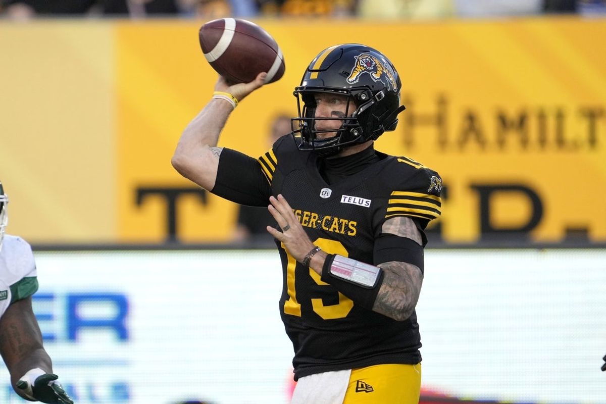Jun 14, 2025; Hamilton, Ontario, Canada; Hamilton Tiger-Cats quarterback Bo Levi Mitchell (19) throws a pass against the Saskatchewan Roughriders during the first half at Hamilton Stadium. Mandatory Credit: John E. Sokolowski-Imagn Images