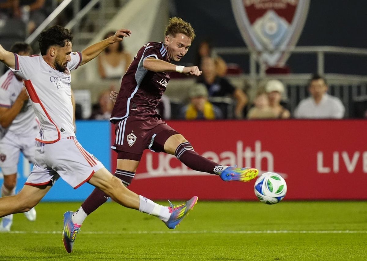 Jun 14, 2025; Commerce City, Colorado, USA; Orlando City midfielder Joran Gerbet (35) defends the shot on goal by Colorado Rapids midfielder Djordje Mihailovic (10) in the second half at Dick's Sporting Goods Park. Mandatory Credit: Ron Chenoy-Imagn Images