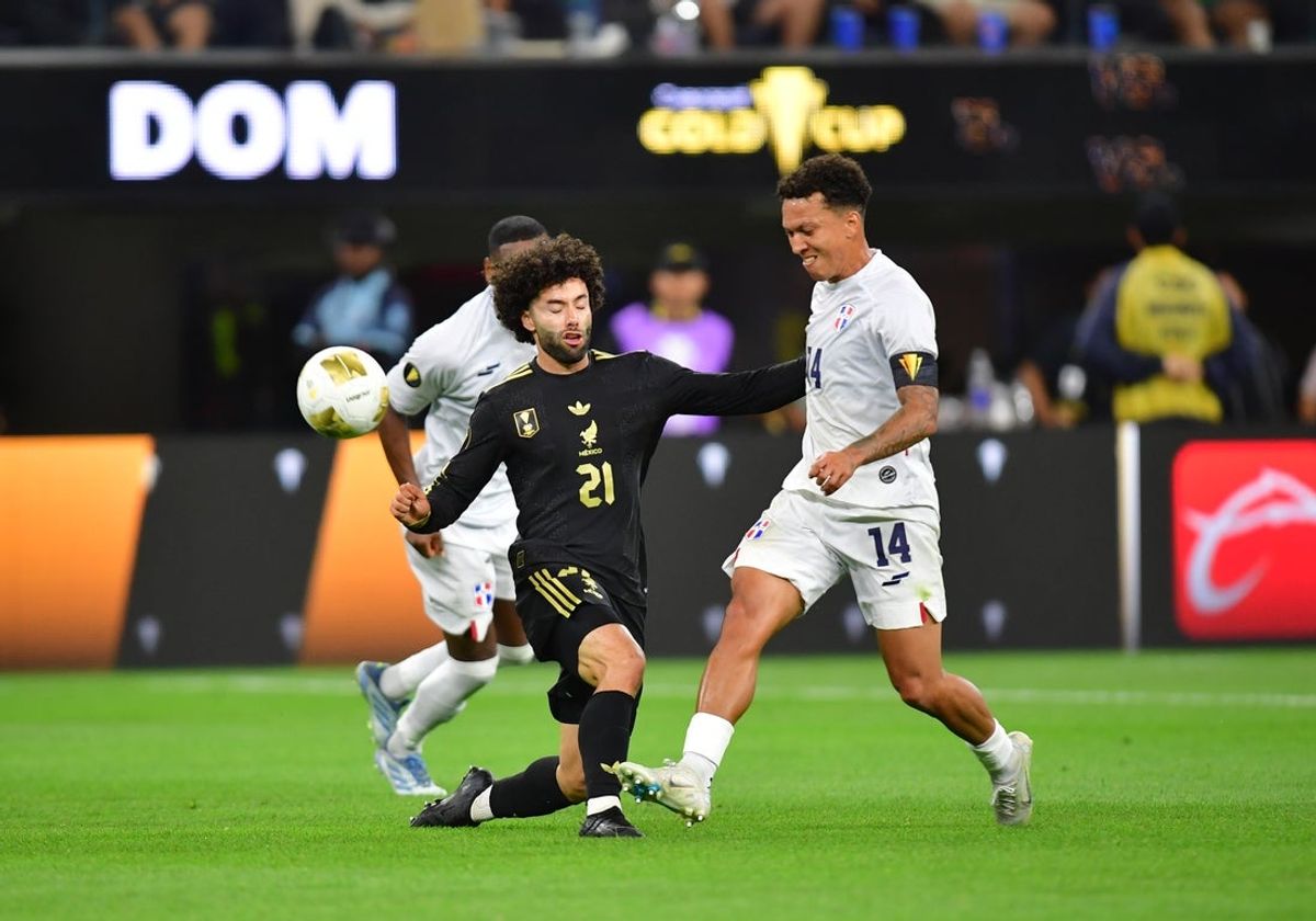 Jun 14, 2025; Inglewood, California, USA; Mexico forward Cesar Huerta (21) and Dominican Republic midfielder Jean Lopez (14) battle for control of the ball during the second half  at SoFi Stadium. Mandatory Credit: Gary A. Vasquez-Imagn Images