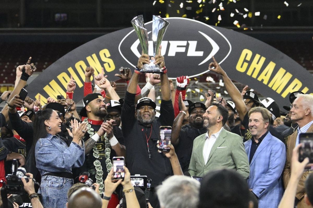 Jun 14, 2025; St. Louis, MO, USA;  DC Defenders head coach Shannon Harris raises the UFL Championship trophy after defeating the Michigan Panthers in the 2025 UFL Championship at The Dome at America’s Center. Mandatory Credit: Jeff Le-Imagn Images