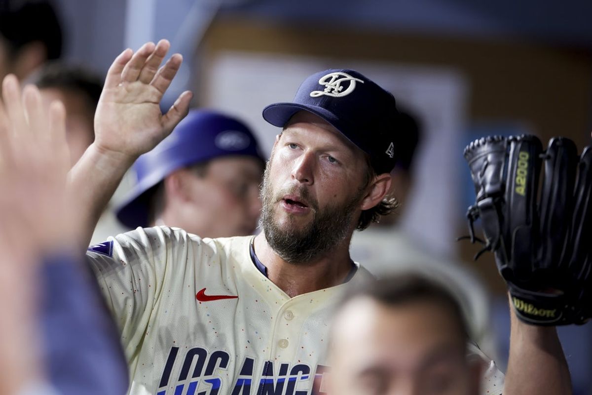 Jun 14, 2025; Los Angeles, California, USA;  Los Angeles Dodgers starting pitcher Clayton Kershaw high fives teammates after coming off the field during the seventh inning of a baseball game against the San Francisco Giants at Dodger Stadium. Mandatory Credit: Ryan Sun-Imagn Images