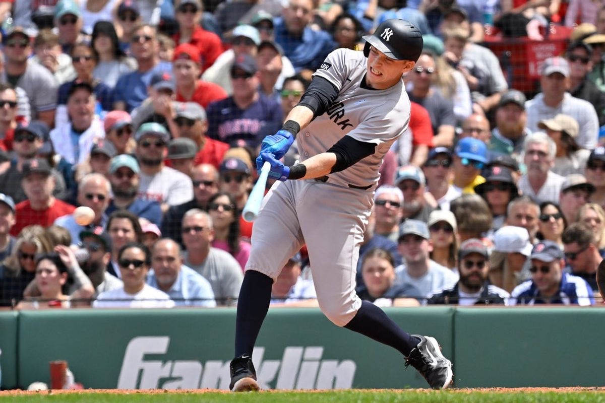 Jun 15, 2025; Boston, Massachusetts, USA; New York Yankees first baseman Ben Rice (22) gets a base hit against the Boston Red Sox during the third inning at Fenway Park. Mandatory Credit: Eric Canha-Imagn Images