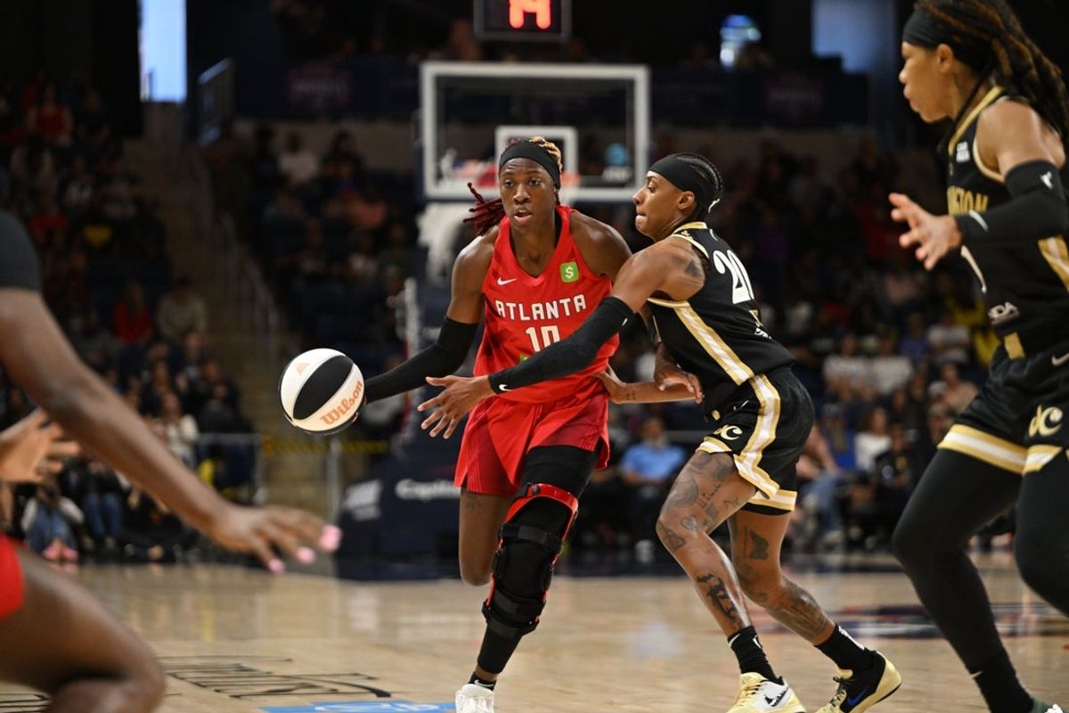 Jun 15, 2025; Washington, District of Columbia, USA; Atlanta Dream guard Rhyne Howard (10) attempts to drive past Washington Mystics guard Brittney Sykes (20) during the second quarter at CareFirst Arena. Mandatory Credit: Rafael Suanes-Imagn Images