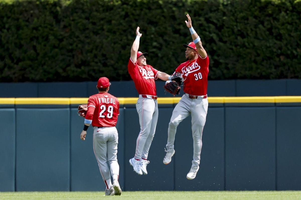 Jun 15, 2025; Detroit, Michigan, USA;  Cincinnati Reds outfielder TJ Friedl (29) first baseman Spencer Steer (7) and outfielder Will Benson (30) celebrate after defeating the Detroit Tigers at Comerica Park. Mandatory Credit: Rick Osentoski-Imagn Images