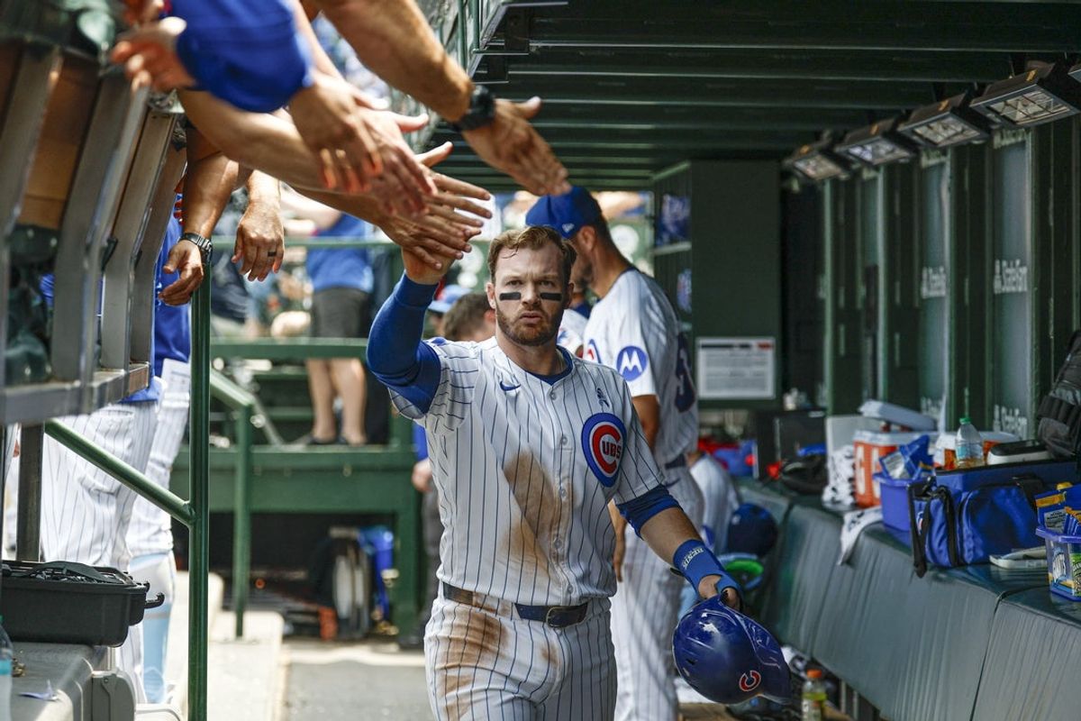 Jun 15, 2025; Chicago, Illinois, USA; Chicago Cubs left fielder Ian Happ (8) celebrates with teammates in the dugout after scoring against the Pittsburgh Pirates during the first inning at Wrigley Field. Mandatory Credit: Kamil Krzaczynski-Imagn Images