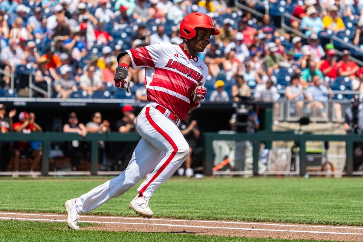 Jun 15, 2025; Omaha, Neb, USA; Louisville Cardinals second baseman Kamau Neighbors (5) runs after hitting a single against the Arizona Wildcats during the third inning at Charles Schwab Field. Mandatory Credit: Dylan Widger-Imagn Images
