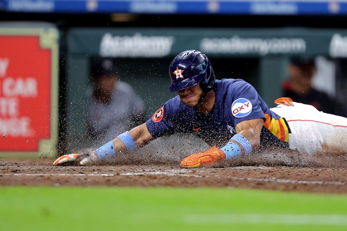 Jun 15, 2025; Houston, Texas, USA; Houston Astros shortstop Jeremy Peña (3) slides across home plate to score a run against the Minnesota Twins during the ninth inning at Daikin Park. Mandatory Credit: Erik Williams-Imagn Images