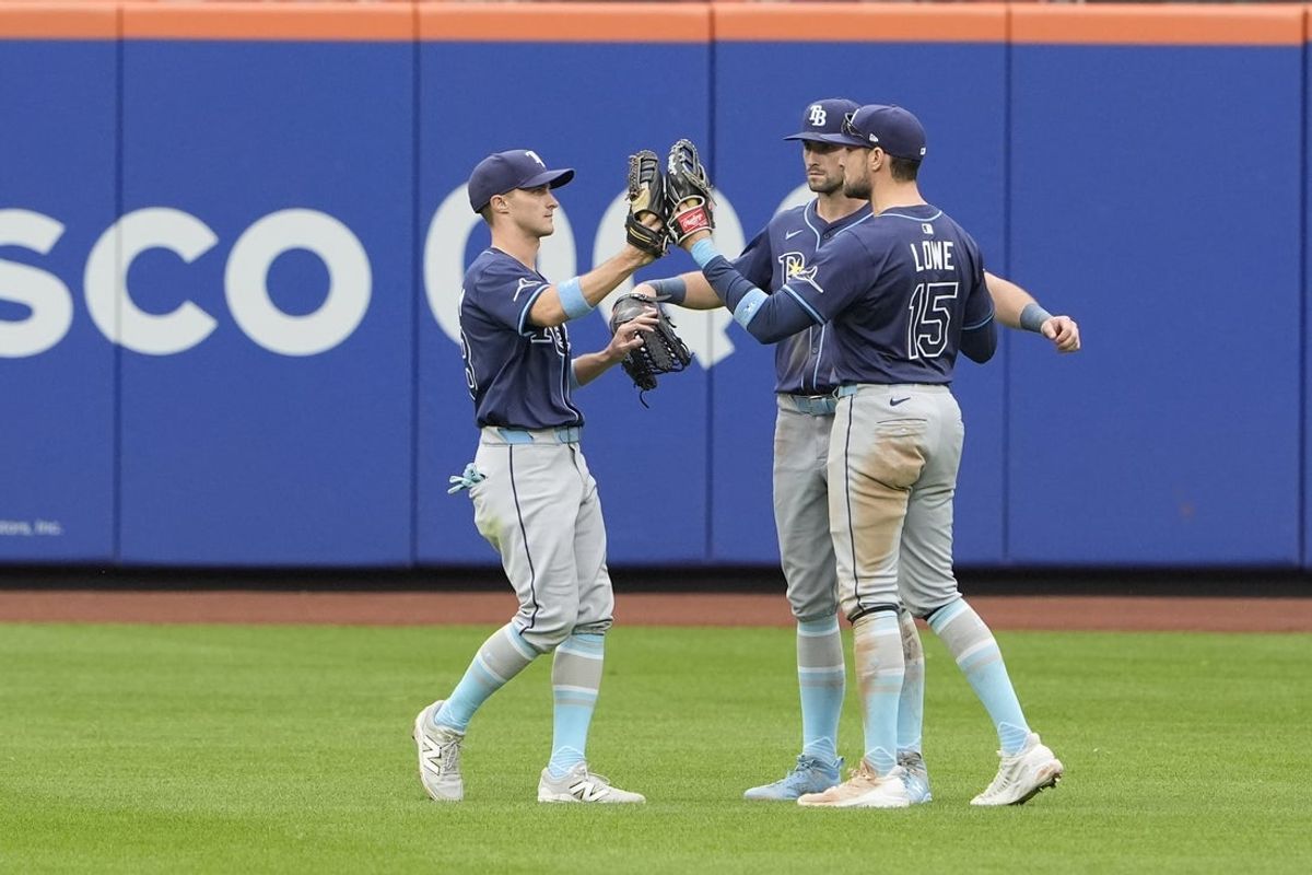 Jun 15, 2025; New York City, New York, USA; Tampa Bay Rays left fielder Jake Margum (28) and center fielder Kameron Misner (26) and right fielder Josh Lowe (15) hi five to celebrate the victory against the New York Mets after during the ninth inning at Citi Field. Mandatory Credit: Gregory Fisher-Imagn Images