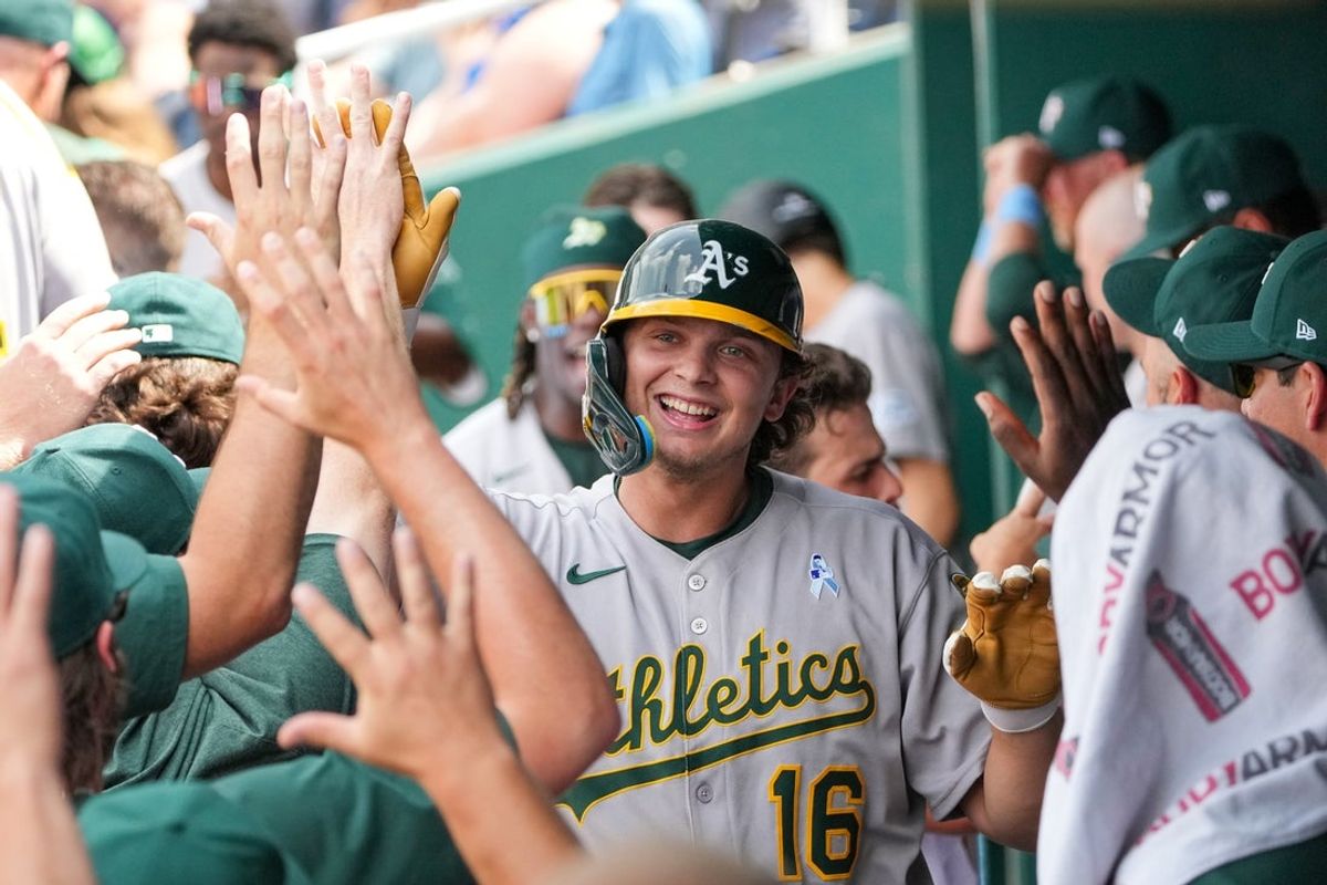 Jun 15, 2025; Kansas City, Missouri, USA; Athletics first base Nick Kurtz (16) is congratulated in the dugout after hitting a solo home run against the Kansas City Royals in the ninth inning at Kauffman Stadium. Mandatory Credit: Denny Medley-Imagn Images
