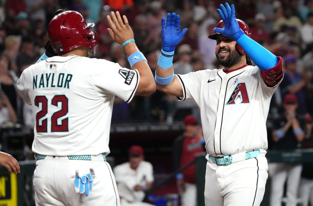 Arizona Diamondbacks Eugenio Suárez (28) celebrates his 2-run home run with teammate Josh Naylor (22) during their game against the San Diego Padres at Chase Field.