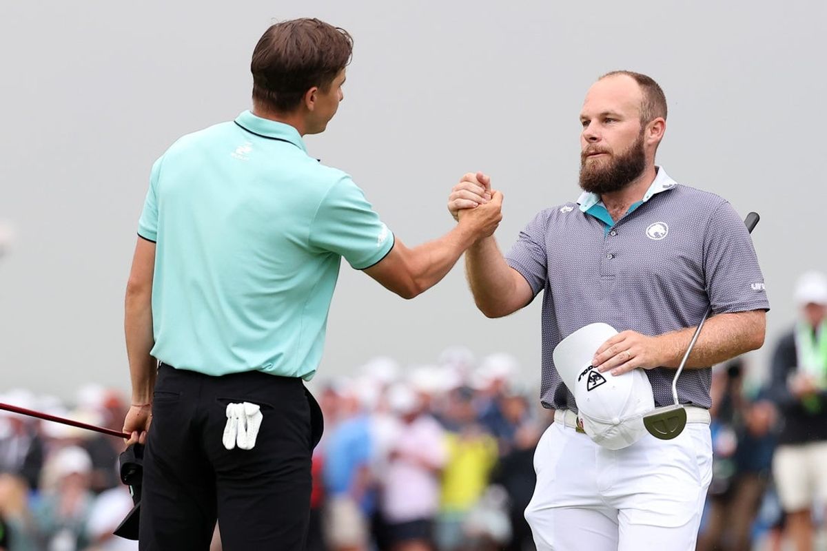 Jun 15, 2025; Oakmont, Pennsylvania, USA; Carlos Ortiz and Tyrrell Hatton shake hands after finishing the 18th hole during the final round of the U.S. Open golf tournament. Mandatory Credit: Bill Streicher-Imagn Images