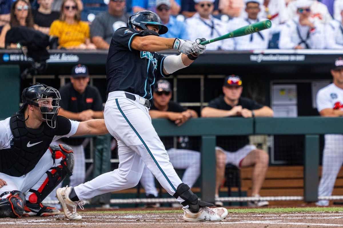 Jun 15, 2025; Omaha, Neb, USA; Coastal Carolina Chanticleers first baseman Colby Thorndyke (16) hits a three RBI double against the Oregon State Beavers during the first inning at Charles Schwab Field. Mandatory Credit: Dylan Widger-Imagn Images