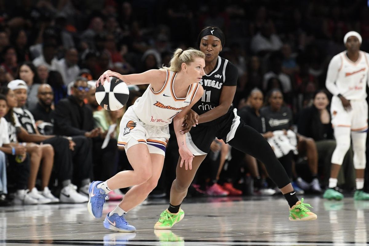Jun 15, 2025; Las Vegas, Nevada, USA; Phoenix Mercury guard Lexi Held (1) dribbles against Las Vegas Aces guard Dana Evans (11) in the fourth quarter at Michelob Ultra Arena. Mandatory Credit: Candice Ward-Imagn Images