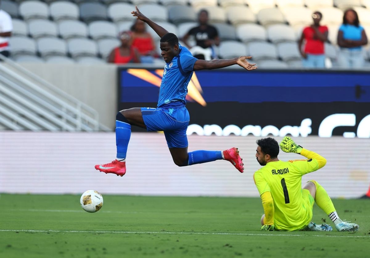 Jun 15, 2025; San Diego, California, USA; Haiti forward Mondy Prunier (16) leaps over Saudi Arabia goalkeeper Nawaf Alaqidi (1) during the second half of a group stage match of the 2025 Gold Cup at Snapdragon Stadium. Mandatory Credit: Chadd Cady-Imagn Images