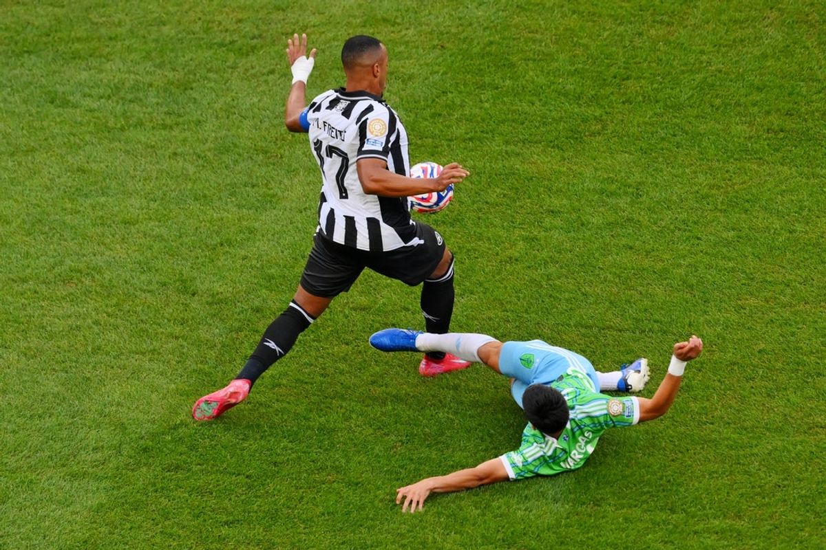 Jun 15, 2025; Seattle, Washington, USA; Seattle Sounders FC midfielder Obed Vargas (18) and Botafogo midfielder Freitas Marlon (17) collide during the first half during a group stage match of the 2025 FIFA Club World Cup at Lumen Field. Mandatory Credit: Steven Bisig-Imagn Images