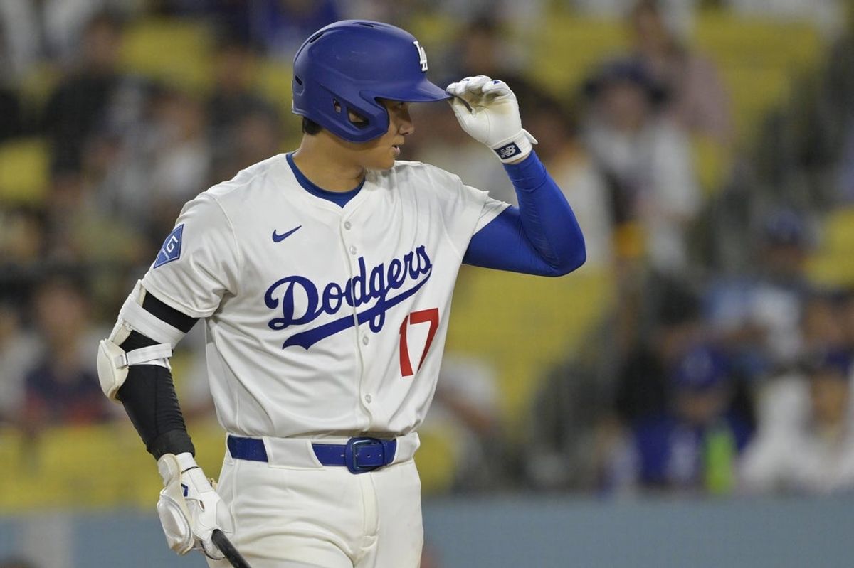 Jun 16, 2025; Los Angeles, California, USA;  Los Angeles Dodgers designated hitter Shohei Ohtani (17) tips his cap to the umpire during his at bat in the eighth inning against the San Diego Padres at Dodger Stadium. Mandatory Credit: Jayne Kamin-Oncea-Imagn Images