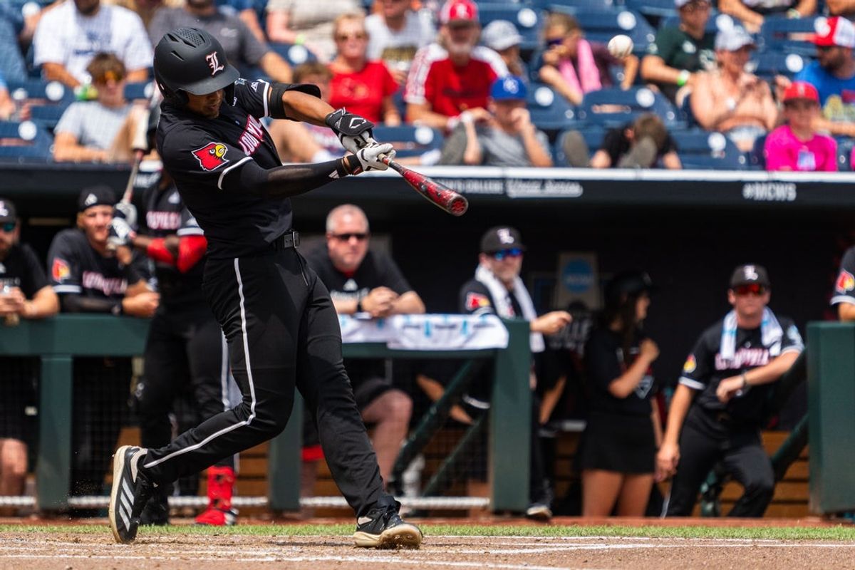 Jun 17, 2025; Omaha, Neb, USA; Louisville Cardinals third baseman Jake Munroe (20) hits a two-run home run against the Oregon State Beavers during the third inning at Charles Schwab Field. Mandatory Credit: Dylan Widger-Imagn Images