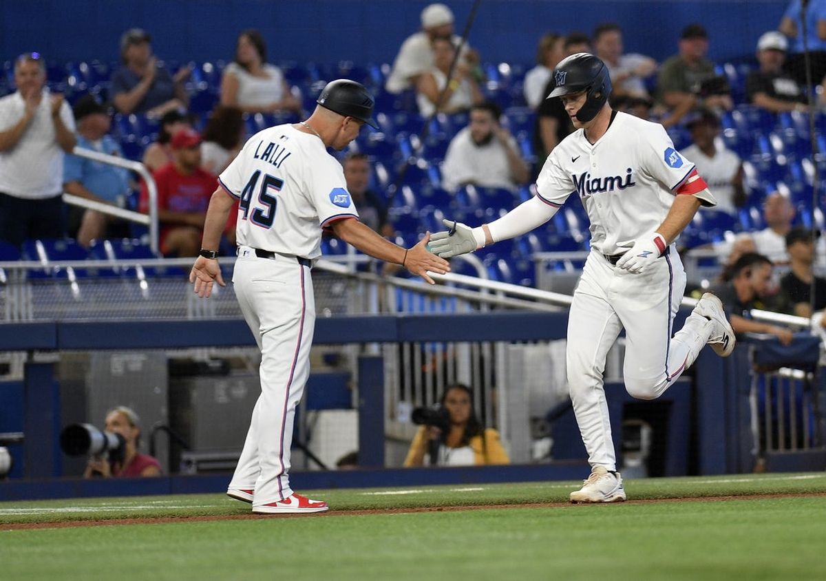 Jun 17, 2025; Miami, Florida, USA;  Miami Marlins’ Eric Wagaman is congratulated by third base coach Blake Lalli (45) after hitting a 2-run home run, during the 2nd inning, against the Philadelphia Phillies at loanDepot Park. Mandatory Credit: Michael Laughlin-Imagn Images
