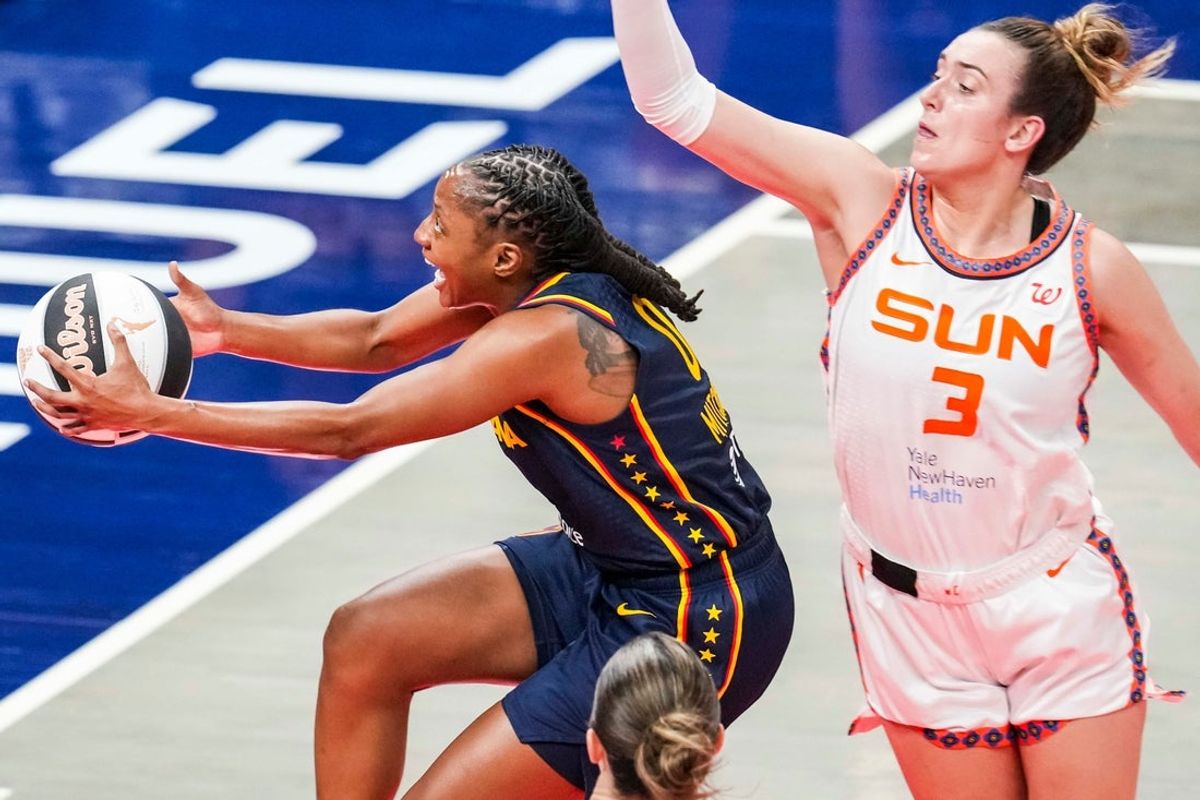 Indiana Fever guard Kelsey Mitchell (0) goes up for a basket against Connecticut Sun guard Marina Mabrey (3) on Tuesday, June 17, 2025, during a game between the Indiana Fever and the Connecticut Sun at Gainbridge Fieldhouse in Indianapolis.