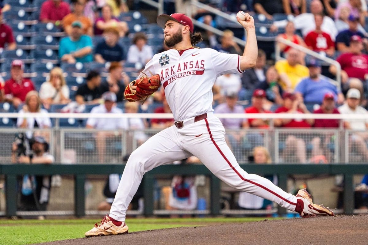 Jun 17, 2025; Omaha, Neb, USA; Arkansas Razorbacks starting pitcher Zach Root (33) pitches against the UCLA Bruins during the first inning at Charles Schwab Field. Mandatory Credit: Dylan Widger-Imagn Images